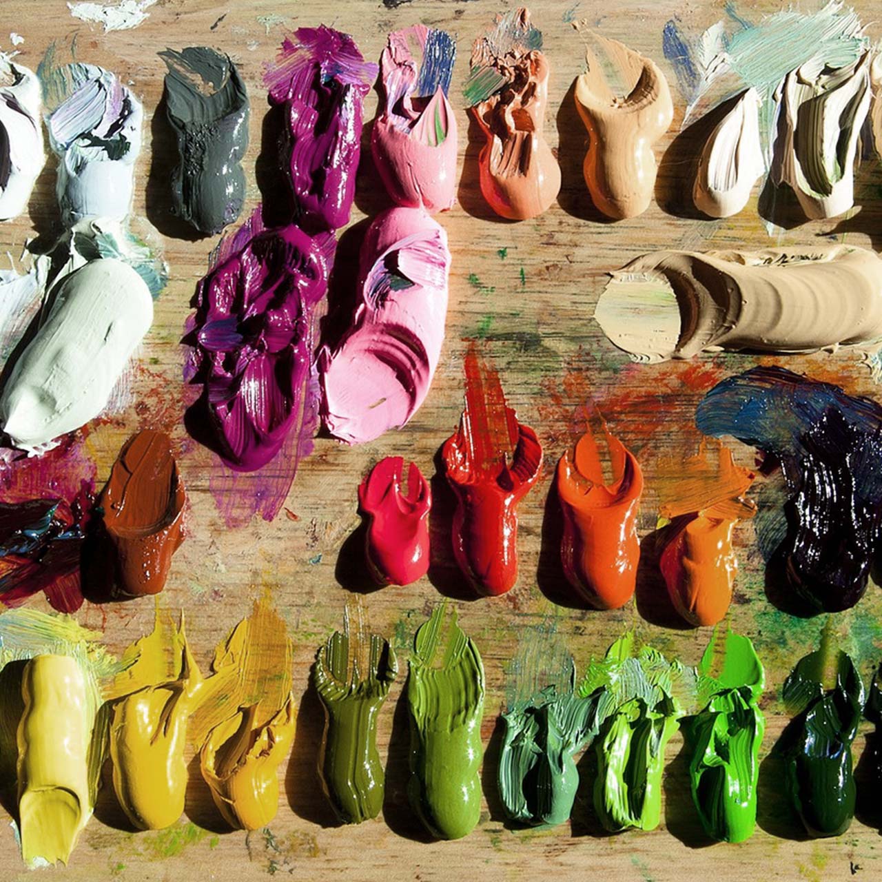 Close up of different oil paint colours arranged o