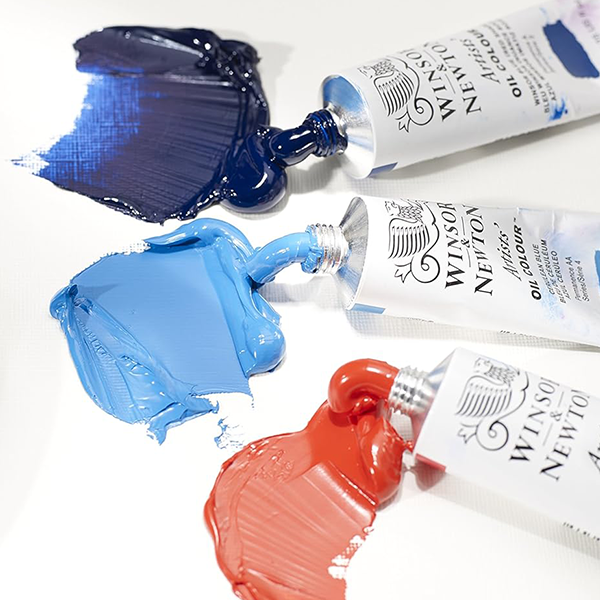 Three open Winsor & Newton paint tubes with paint 